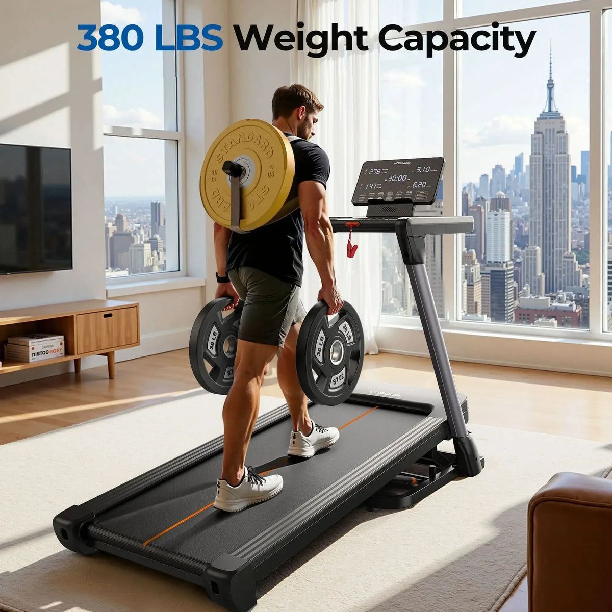 Person using a treadmill with weight capacity display in a room with large windows showing a cityscape.